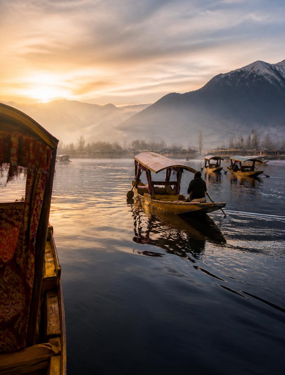 Shikaras on a misty Dal Lake at dawn